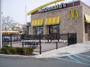 Commercial aluminum fence around a McDonald's restaurant, featuring Style 9 with rings.