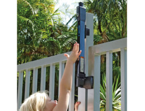 Top Pull Magna Latch, child safety pool gate lock with a small child attempting to unlock.