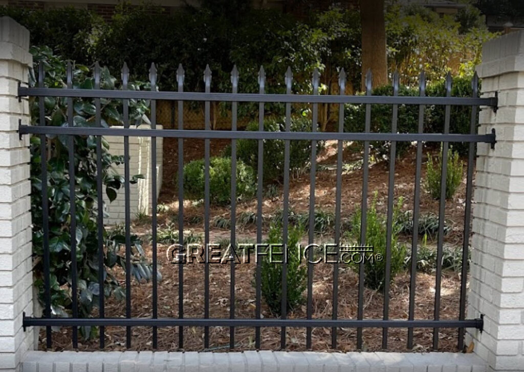 Commercial aluminum fence panel mounted between columns using rail end mounts