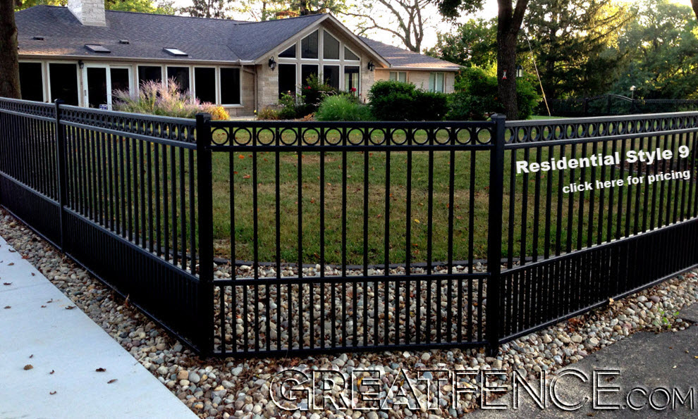 installed aluminum fence with decorative circles and flat top puppy pickets to keep the owner's dog inside the property