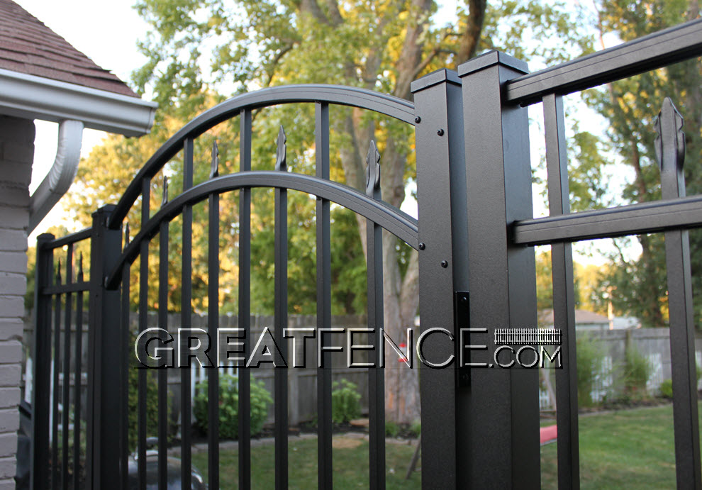 closeup view: arched aluminum gate with puppy pickets