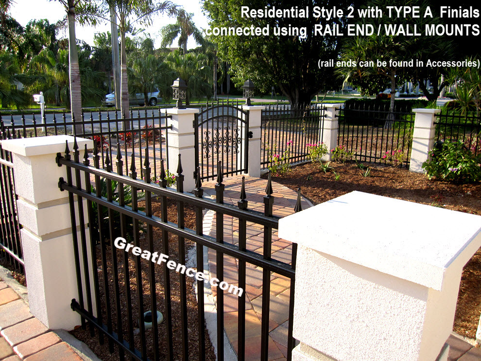 bronze aluminum fence with rail end brackets connecting to stucco columns